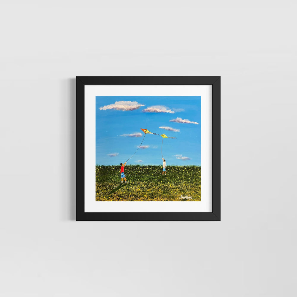 two boys playing with kites in green field and blue sky with white clouds
