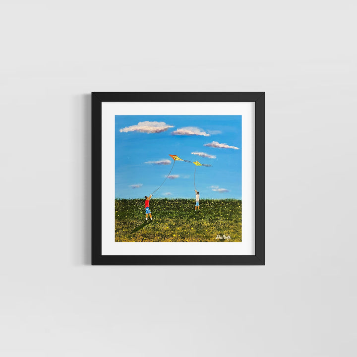 two boys playing with kites in green field and blue sky with white clouds