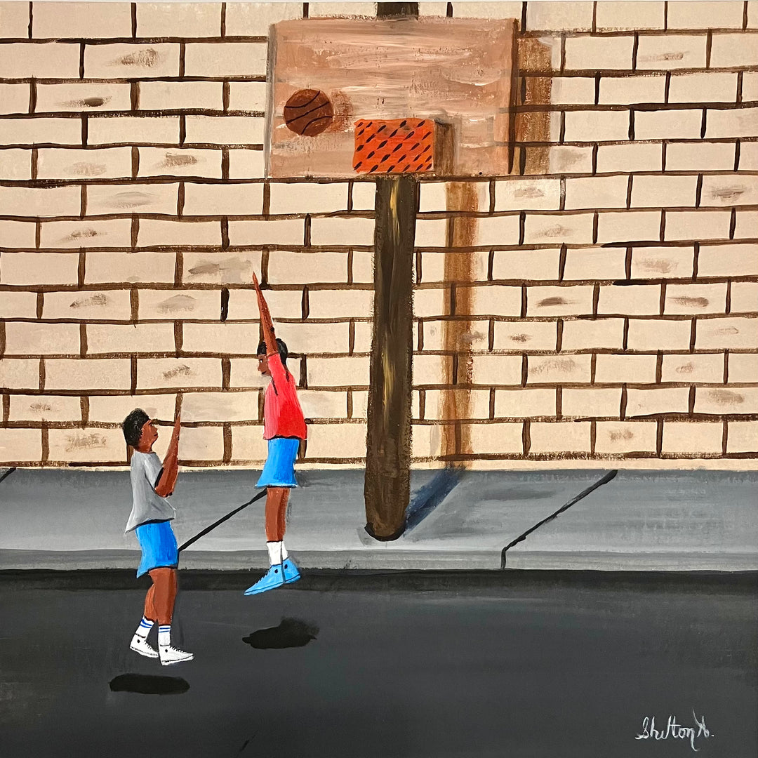 two boys playing blocking basketball on street net hoop in front of brick wall