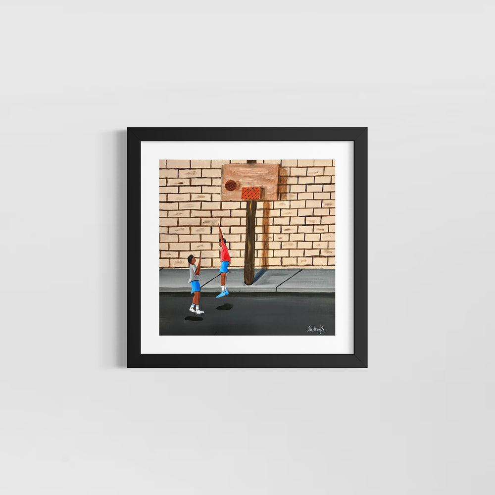 two boys playing blocking basketball on street net hoop in front of brick wall