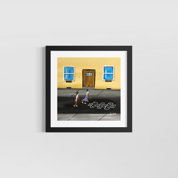 two girls playing hopscotch outside chalk street in front of house with door and windows