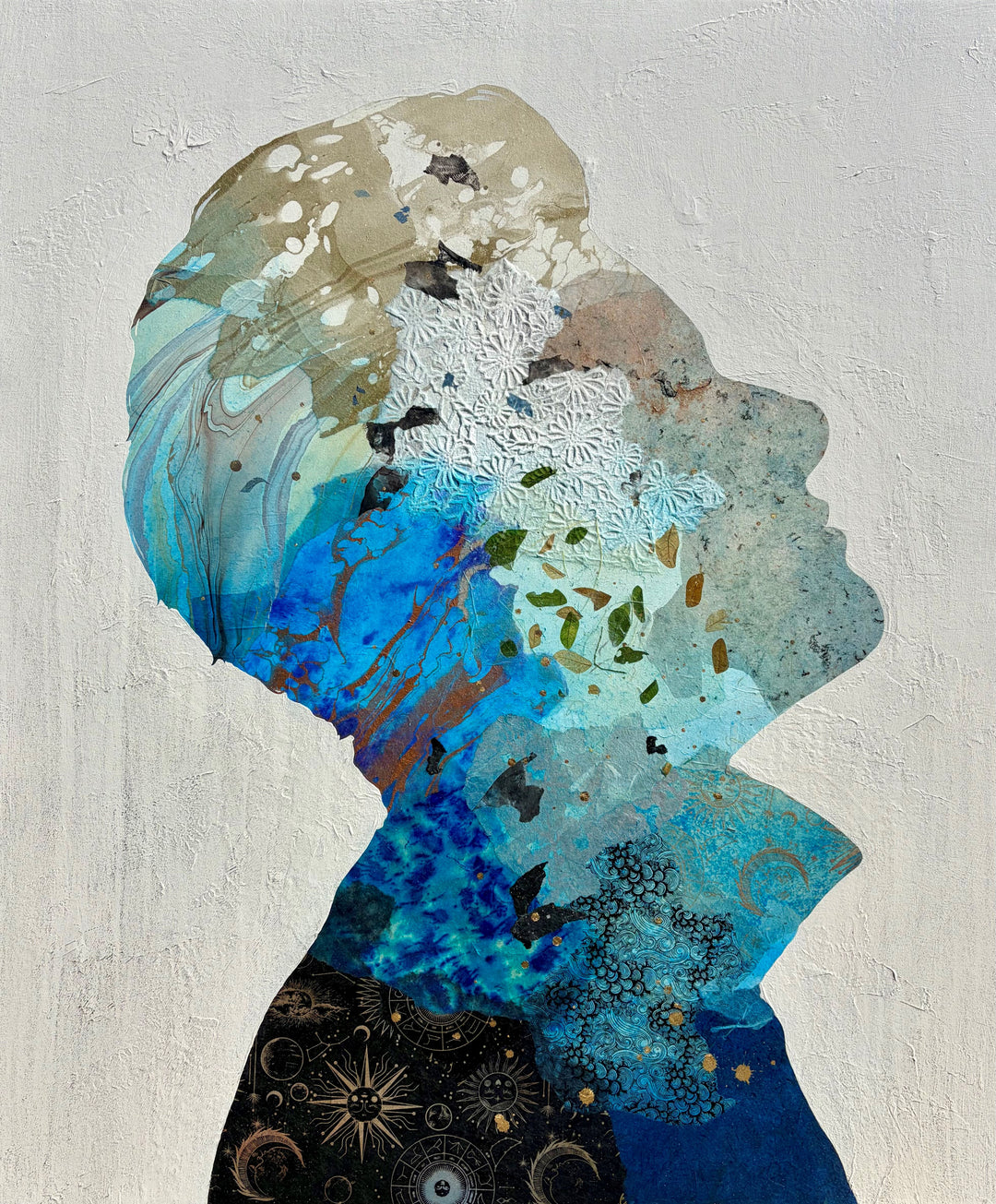 Christopher Peter, Born to Be Blue, acrylic, oil, handmade papers and gold leaf on canvas, 48 x 40 inches. Full view of an upward-facing profile silhouette made of layered blue, turquoise, tan, and black collaged papers with white embossed floral paper, scattered leaves, and gold leaf accents on a textured off-white background.