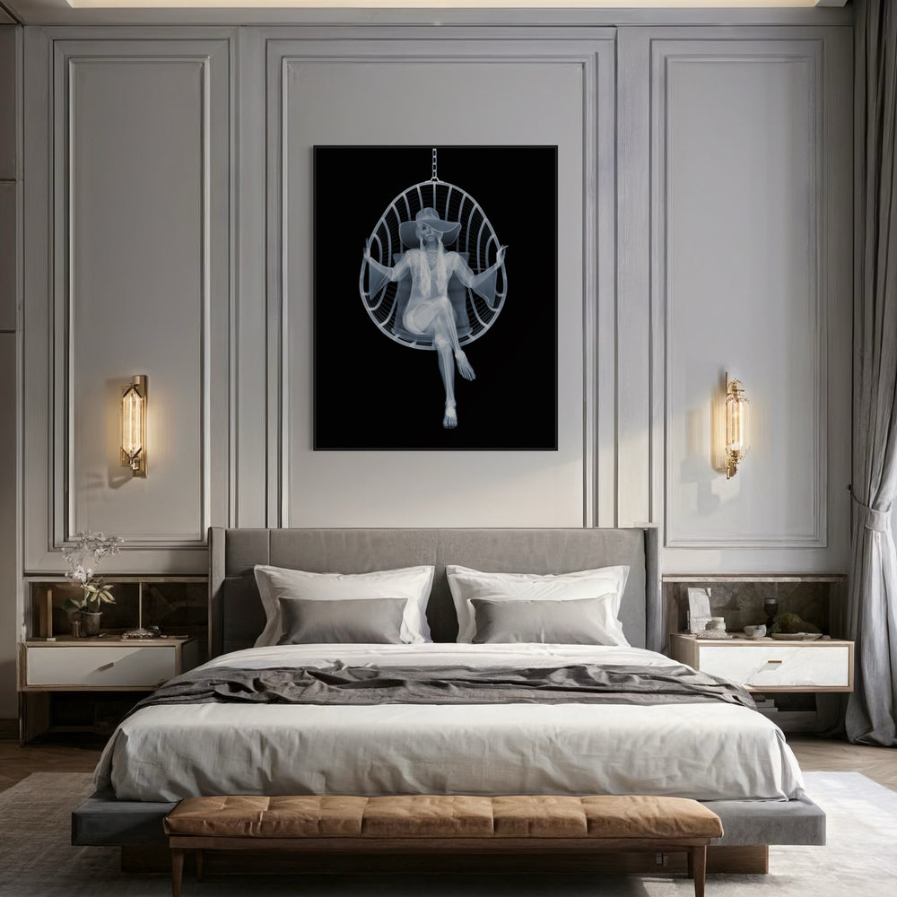 Framed Chromaluxe black and white x-ray photograph by Nick Veasey of a skeleton woman sitting in a swing chair with long pigtails, large hat and boho style dress crossing her legs