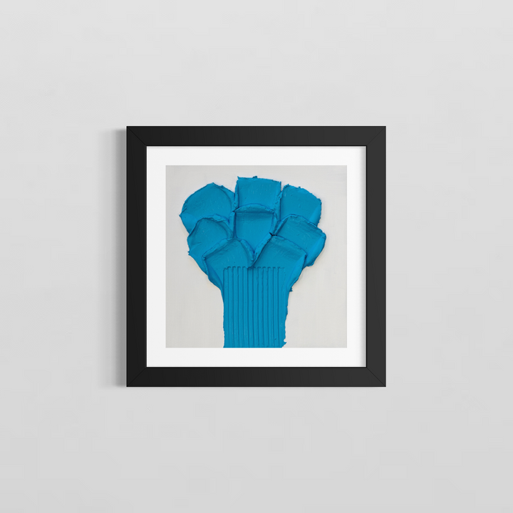 Lee in Cerulean, Botanic Bleu, joint compound and acrylic, 14 x 14 inches, shown in a black frame with a white mat on a light grey wall. A bright blue flower-like form of layered petal shapes on a vertically ribbed stem, on a white background.