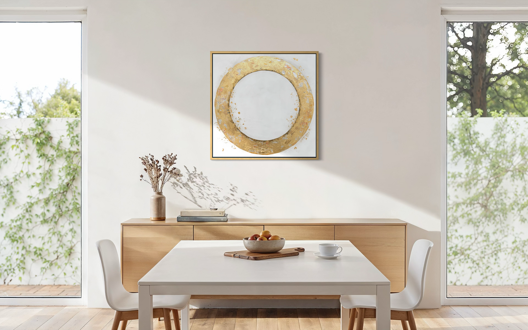 36X36 gold leaf circle on a slightly textured white background with gold and silver leaf dispersed throughout in a dining room scene