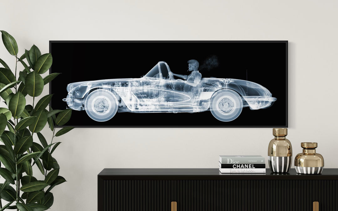 Framed Chromaluxe black and white x-ray photograph by Nick Veasey of a skelton man driving a vintage corvette cruiser while spoking a cigarette