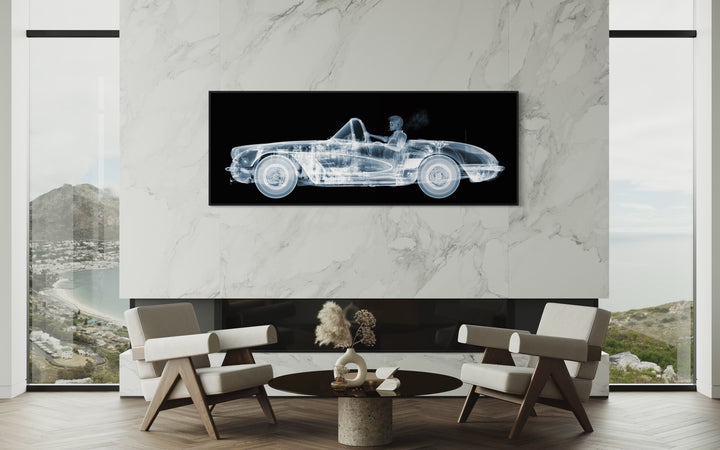 Framed Chromaluxe black and white x-ray photograph by Nick Veasey of a skelton man driving a vintage corvette cruiser while spoking a cigarette