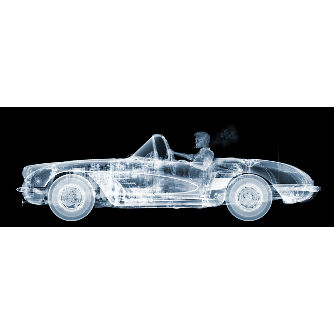 Framed Chromaluxe black and white x-ray photograph by Nick Veasey of a skelton man driving a vintage corvette cruiser while spoking a cigarette