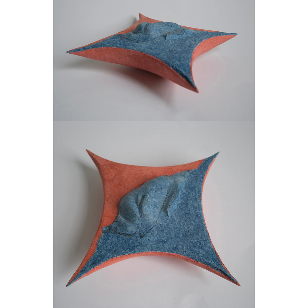 four sided curved inward sculpture in blue and  orange sharp point edges texture