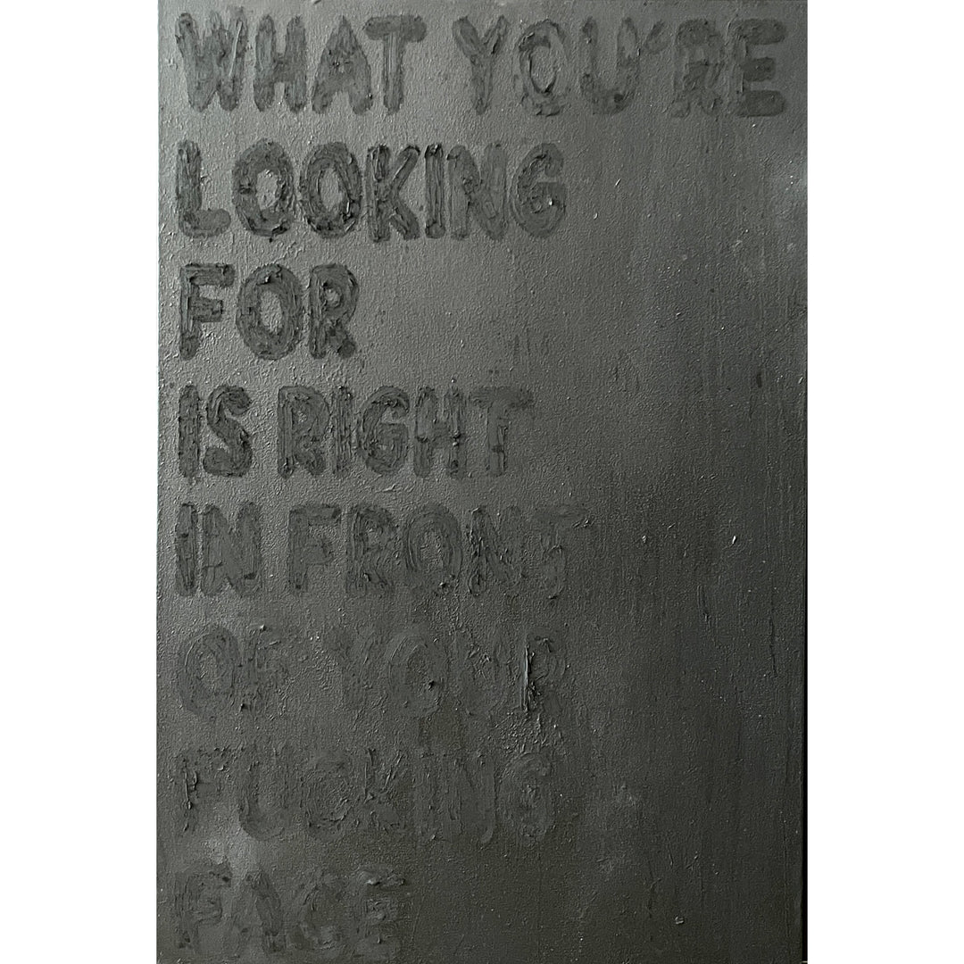black textured oil pastel dark text reading what you're looking for is right in front of your fucking face