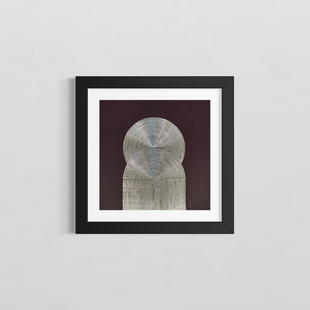Lee in Cerulean, Eminence Duo I, joint compound, liquid leaf and acrylic, 14 x 14 inches, shown in a black frame with a white mat on a light grey wall. Two overlapping silver forms, a circle above an arch, both formed from concentric raised lines, on a dark plum background.
