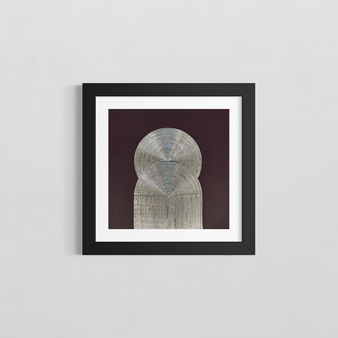 Lee in Cerulean, Eminence Duo I, joint compound, liquid leaf and acrylic, 14 x 14 inches, shown in a black frame with a white mat on a light grey wall. Two overlapping silver forms, a circle above an arch, both formed from concentric raised lines, on a dark plum background.
