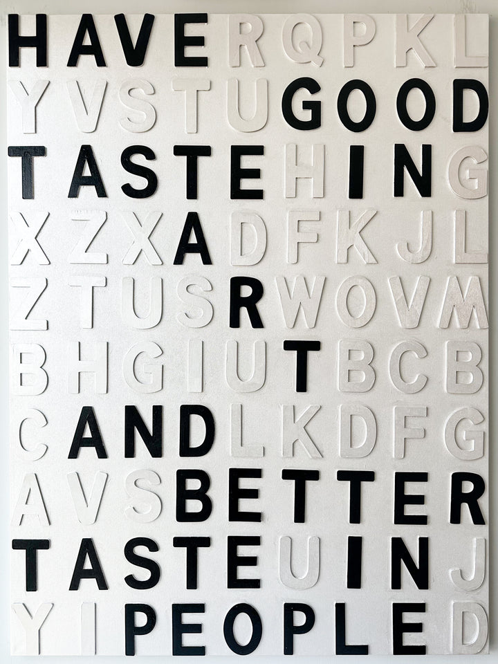 Steffanie Gerkin Have Good Taste White 3D, a contemporary mixed-media text artwork made with wood and acrylic on canvas, featuring raised black and white letters in a bold typographic composition.
