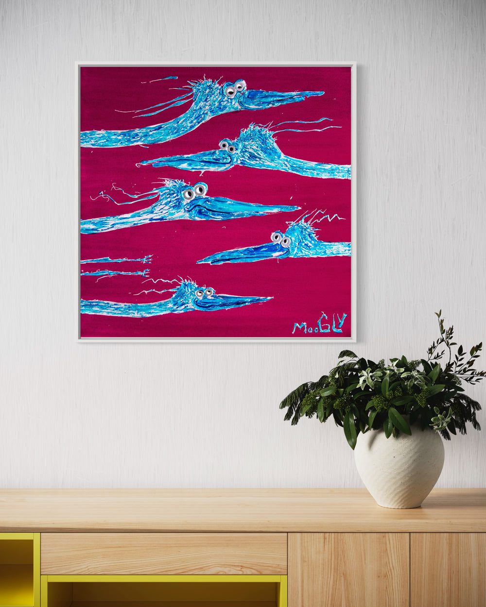 Rush Hour hanging on wall in a frame above plant