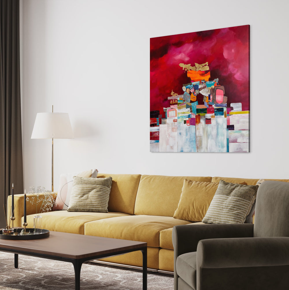 48" x 48" painting by Lau Blou, collaged pieces of torn and hand cut paper and fabrics with patterns and gold foil building up to triangular shape in middle of canvas on pink background with white on the bottom half