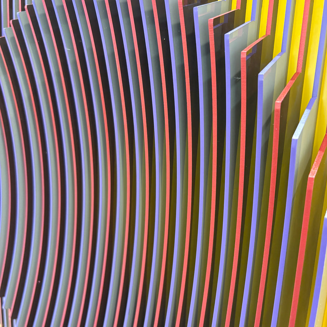 geometric abstract vertical lines concave optical illusion of a circular shape in middle in yellow red and blue