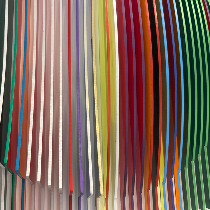 from view vertical stripes on white background in rainbow colors all convex and concave optical illusion to create circle from front, jagged from side and color more prominent