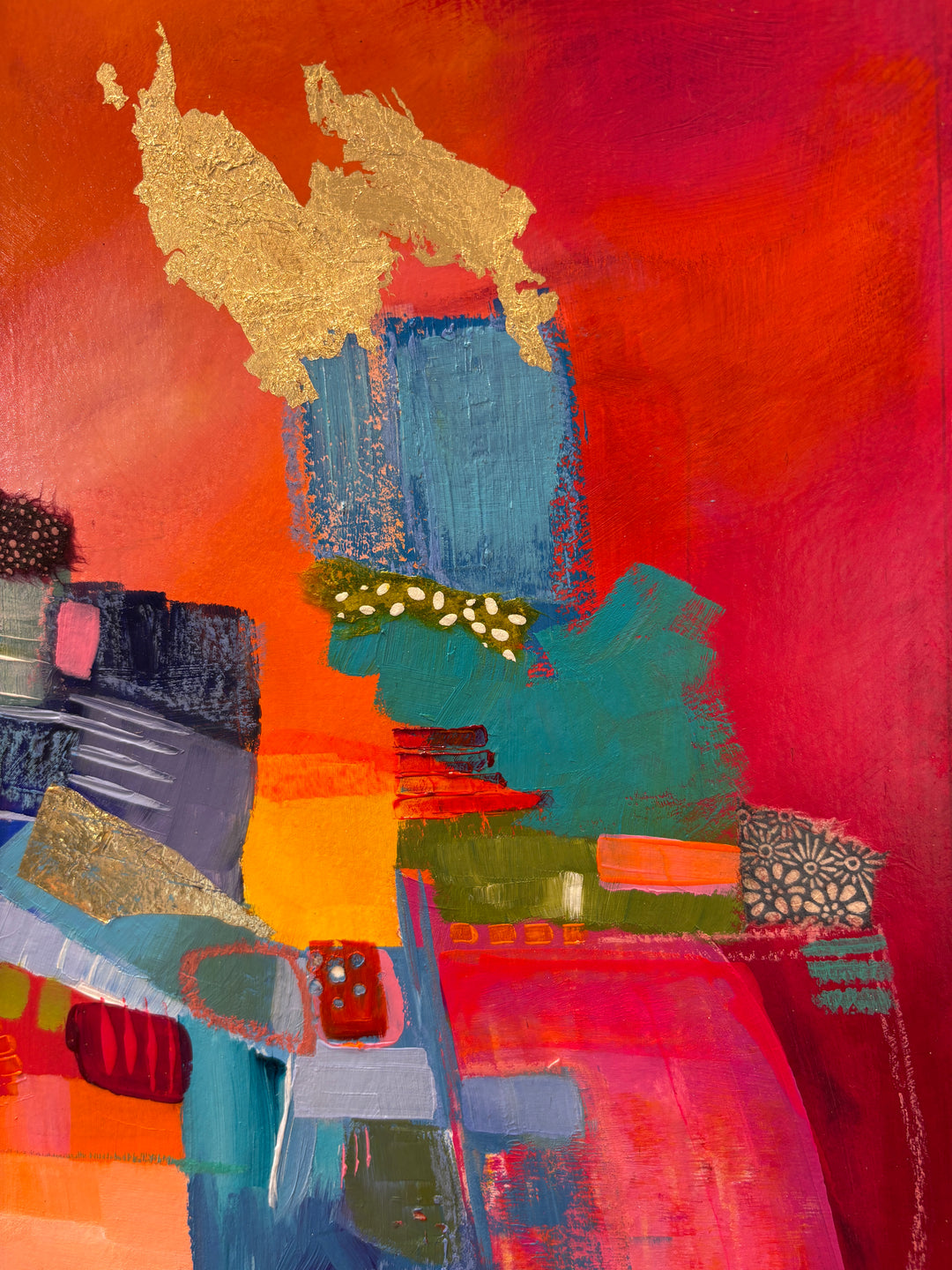 abstract collage of paint in organic shapes and fabric gold leaf graphite blue squares on pink cloudy background 