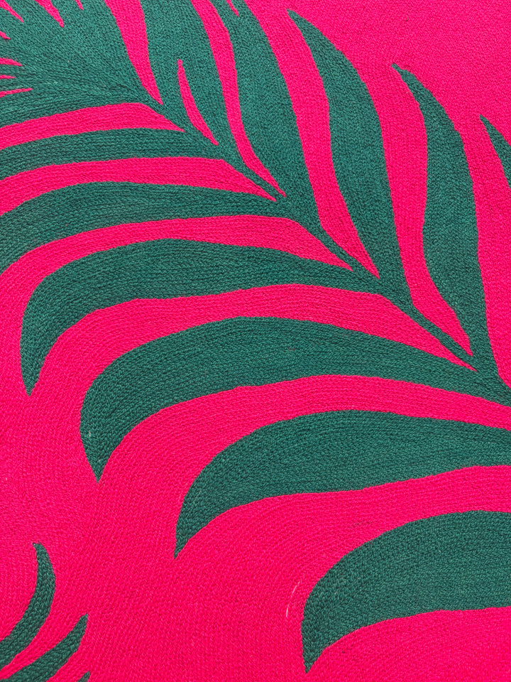 42.5"x42.5" chain-stitched textile with two tropical leafs over a bright pink background. 