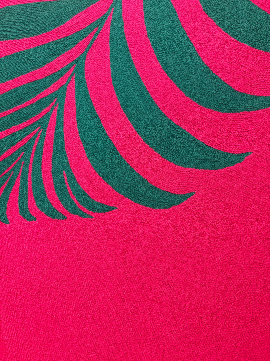 42.5"x42.5" chain-stitched textile with a tropical leaf over a bright pink background. 