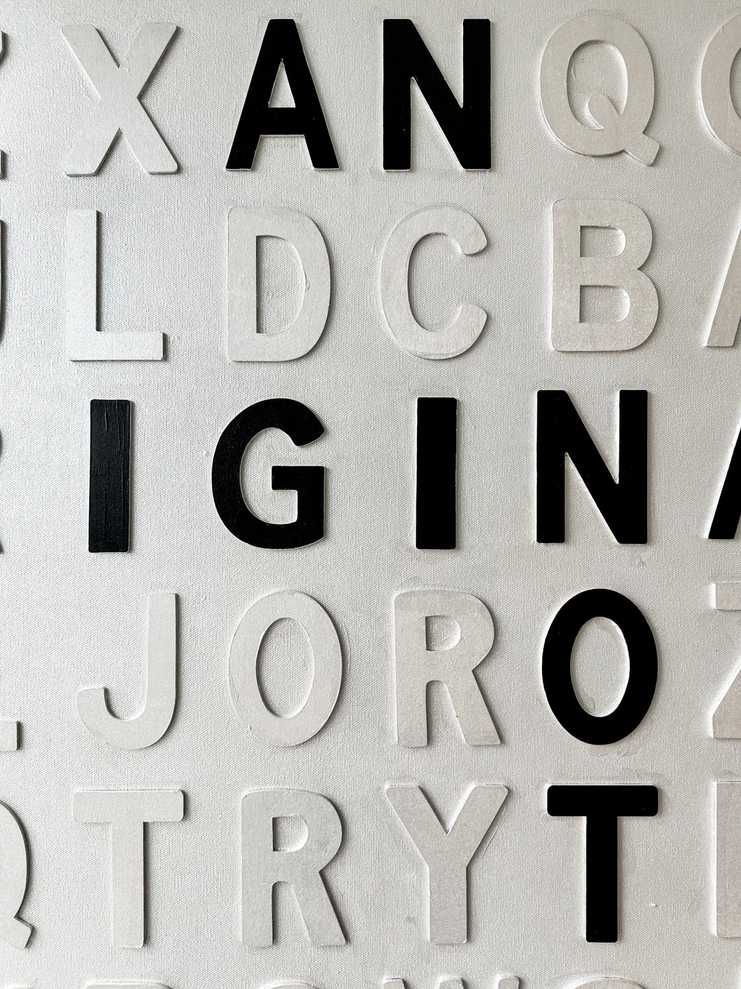 Contemporary 3D text artwork by Chicago artist Steffanie Gerkin titled I’m an Original 3D, featuring raised black and white wood letters arranged in a structured alphabet grid on a white canvas. The monochrome typographic composition spells the phrase “I’m an Original, Not a Print,” creating a bold conceptual wall art piece with graphic text-based design, pop art influence, and contemporary mixed-media style.