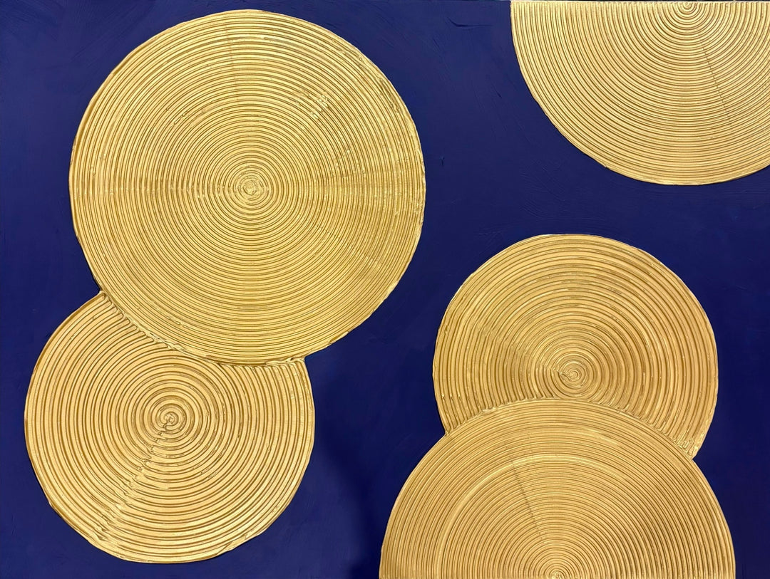 Indigo Awakening II by Lee in Cerulean. Acrylic mixed media painting of textured golden circles, overlapping on top of a dark blue background.