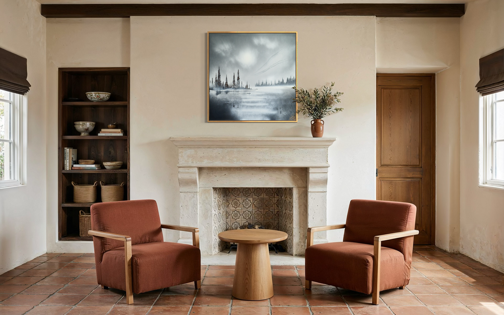 Julien Rey, Infinity, lacquer and gold leaf on board, 40 x 40 inches, shown framed above a stone fireplace in a Spanish-style living room with a terracotta tile floor, bookshelf, and two rust-colored armchairs.