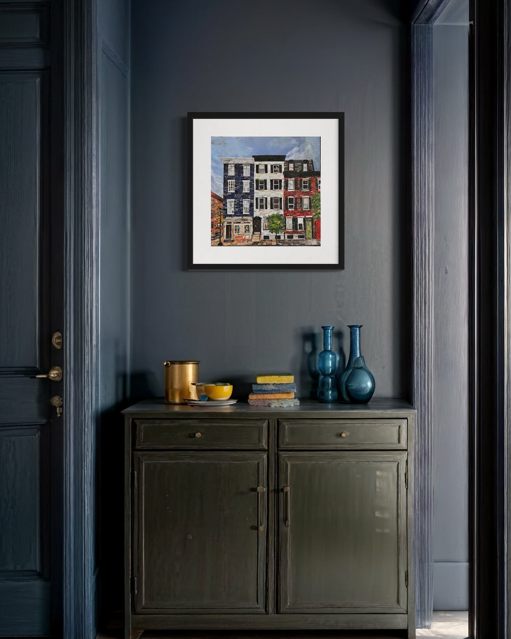 17" x 17" torn paper collage on canvas by Chrissy McIntyre. Artwork of Locust Street rowhomes in Philadelphia, featuring east coast architecture, and brick houses in red, blue and white.