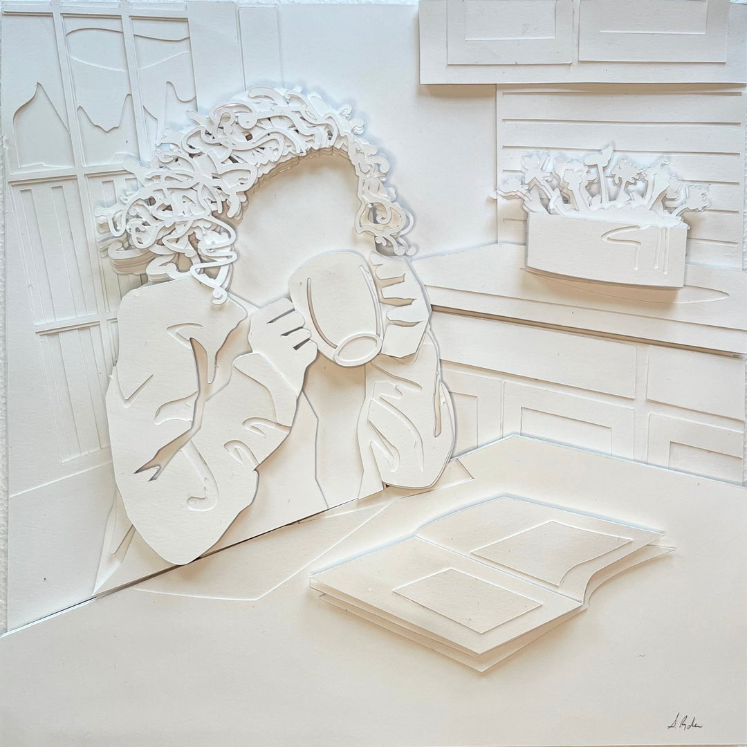 14"x14" layered white paper forming a woman drinking coffee and reading. 