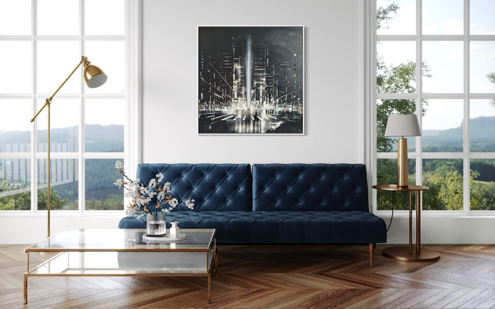 Julien Rey, Night Call, lacquer and gold leaf on board, 40 x 40 inches, shown framed above a navy blue tufted sofa in a modern living room with floor-to-ceiling windows overlooking hills.