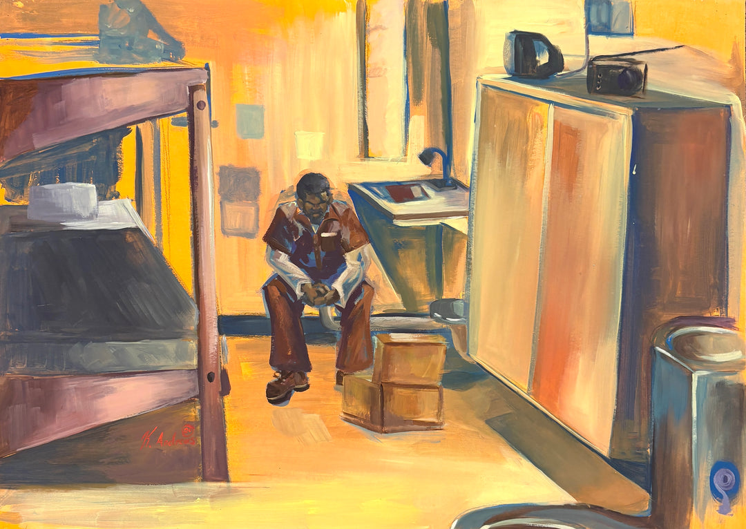man sitting alone in empty prison cell with bed dresser in orange and brown tones