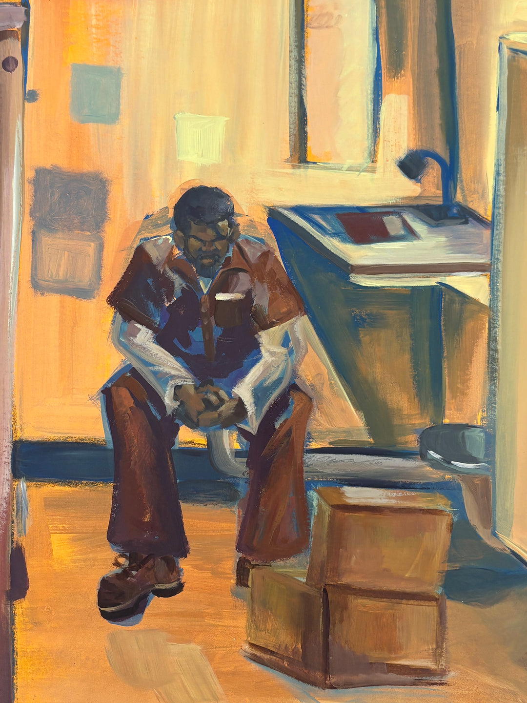 man sitting alone in empty prison cell with bed dresser in orange and brown tones