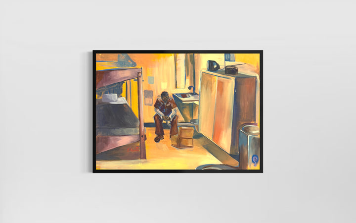 man sitting alone in empty prison cell with bed dresser in orange and brown tones