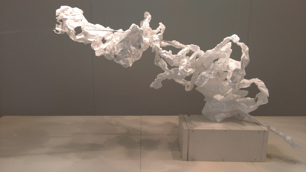 white arching shaped organic and fluid fragile fabric over pole