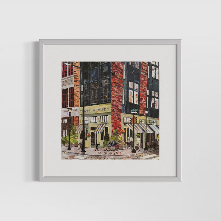 17" x 17" matted torn paper collage artwork by Chrissy McIntyre. Art of Pearl and Mary Oyster Bar in Philadelphia, view of street corner with signs and lampposts, done in yellow, black and red.