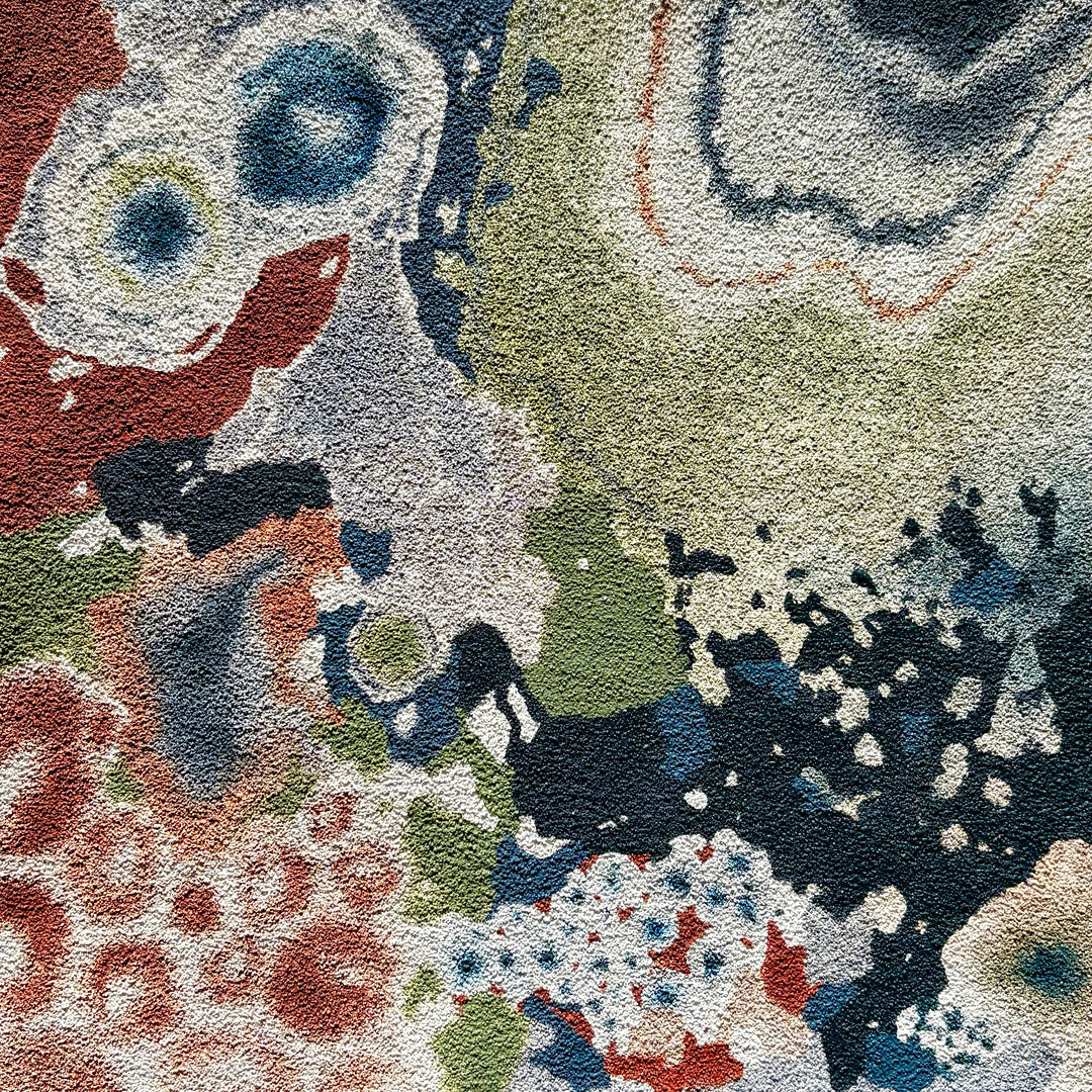 abstract organic shapes gradient petri bacteria in green blue and brown on textured pumice surface