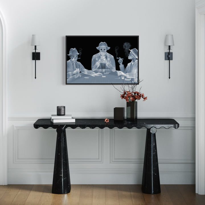 Framed Chromaluxe black and white x-ray photograph by Nick Veasey of three skeletal figures in fedoras and suits playing poker at a table and smoking cigars and holding drinks.