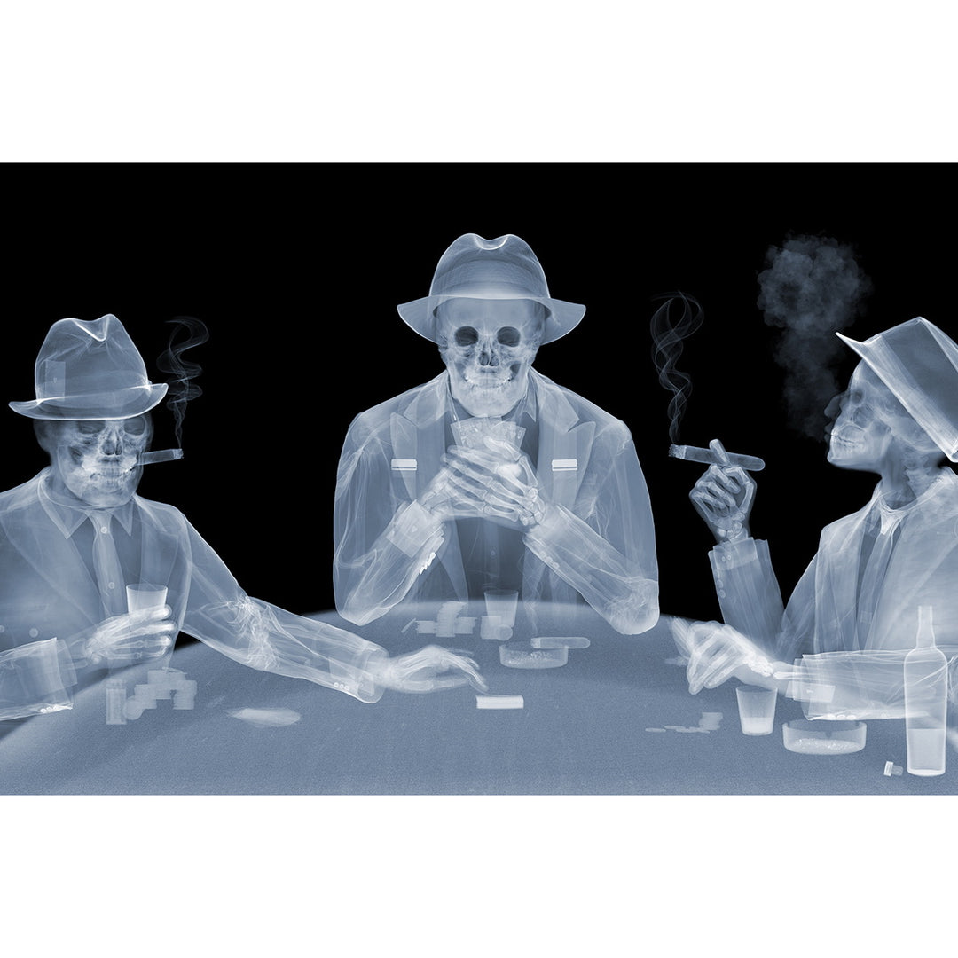 Framed Chromaluxe black and white x-ray photograph by Nick Veasey of three skeletal figures in fedoras and suits playing poker at a table and smoking cigars and holding drinks.