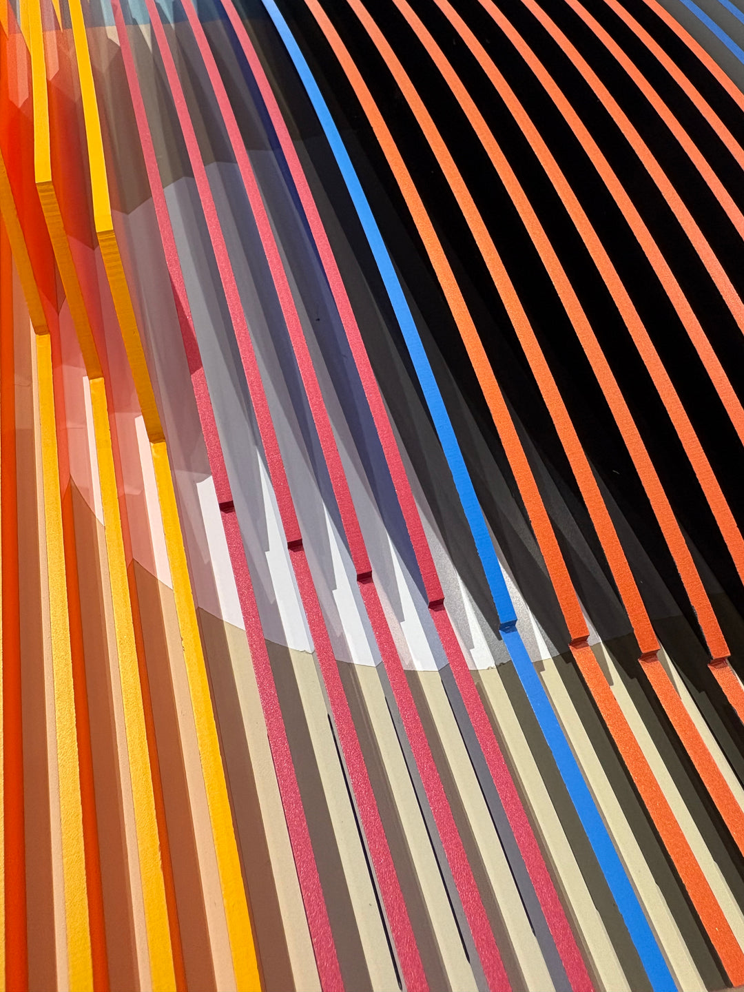 Porthole 361 by José Margulis – diagonal detail of the orange, yellow, pink, and blue plexiglass strip layers
