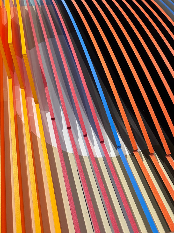 Porthole 361 by José Margulis – diagonal detail of the orange, yellow, pink, and blue plexiglass strip layers