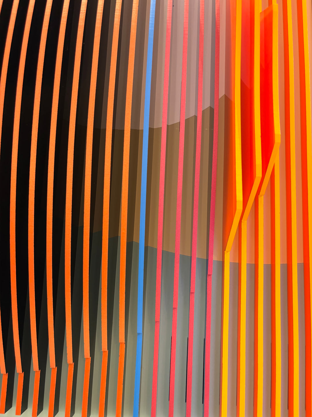 Porthole 361 by José Margulis – close-up detail of the orange, pink, and blue plexiglass strips with a vivid red accent edge