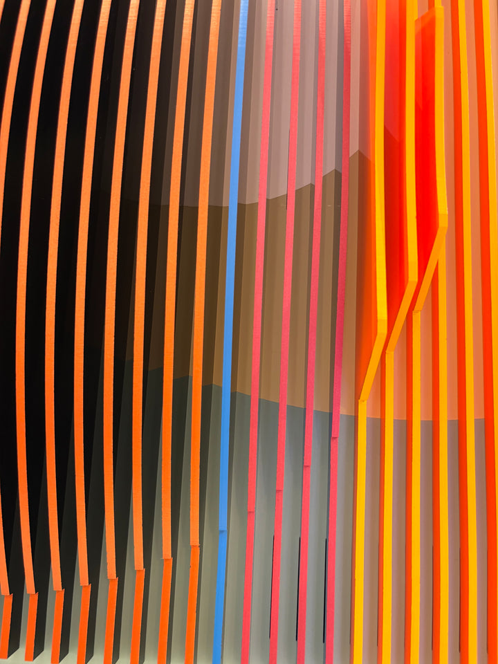 Porthole 361 by José Margulis – close-up detail of the orange, pink, and blue plexiglass strips with a vivid red accent edge