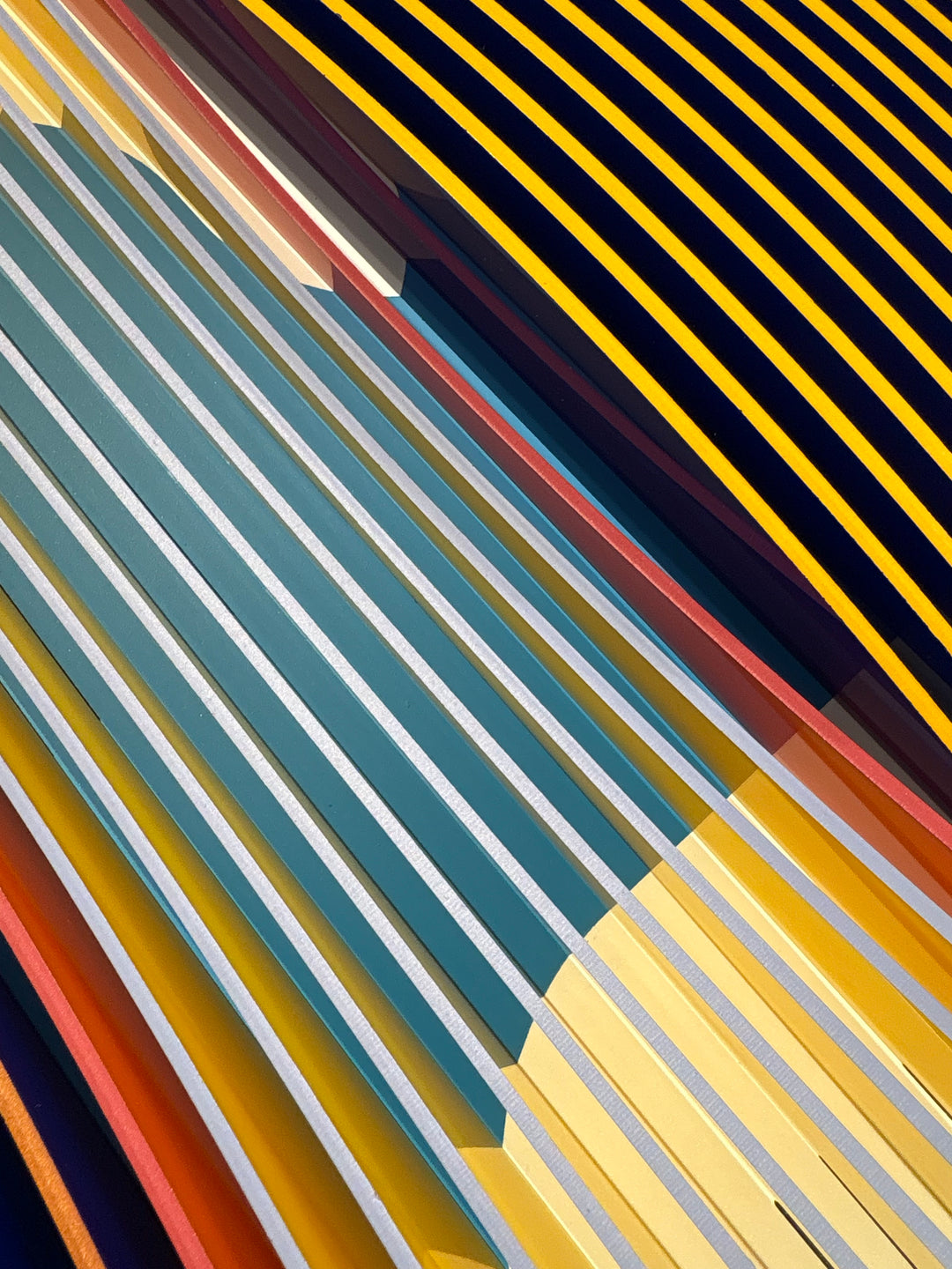 Porthole 440 by José Margulis – diagonal detail of the teal, red, and gold plexiglass strip layers