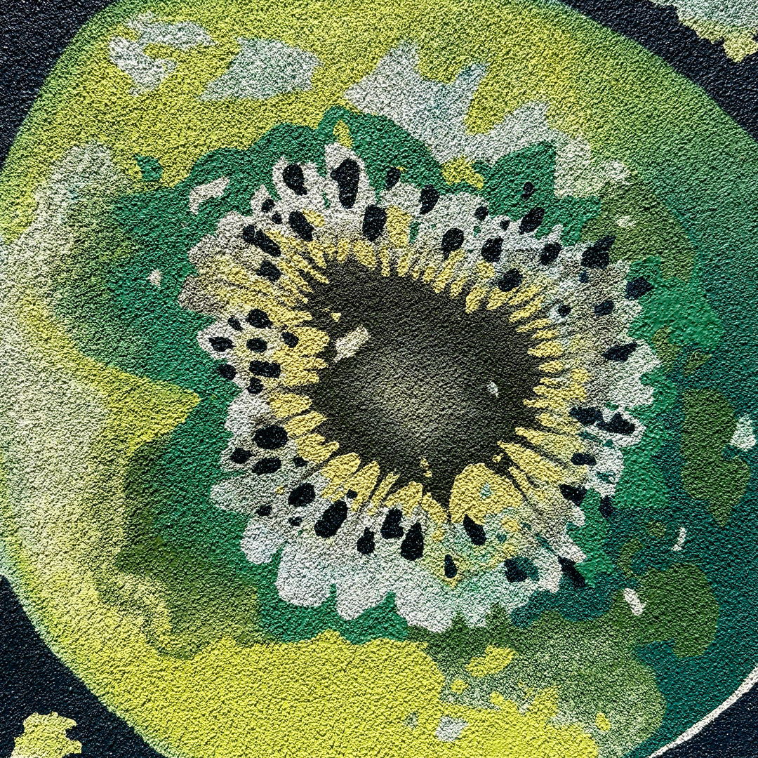 Abstract shapes of green fruit cut in half organic line work and small dot shapes on pumice textured surface