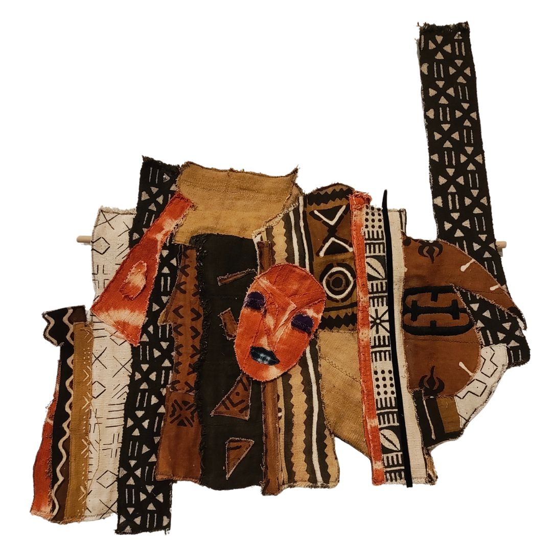 quilted patterned fabric arranged with abstract face portrait mask  in front, wall hanging