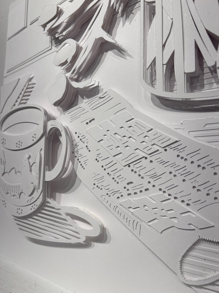 14"x14" paper cut collage featuring a coffee mug and crossword puzzle. 