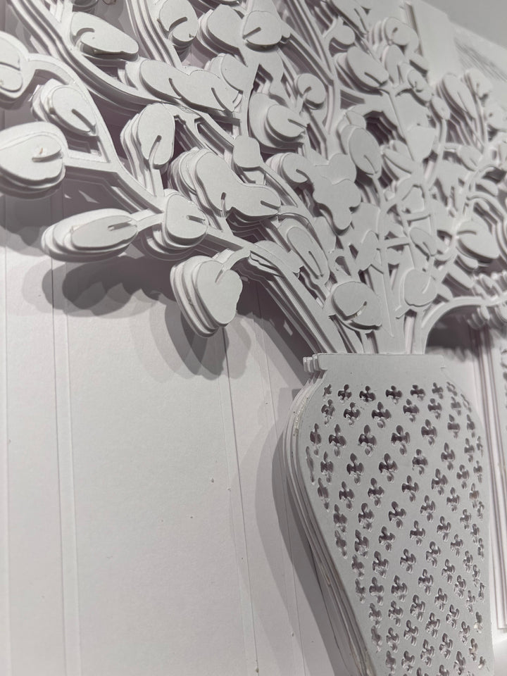 14"x14" layered white paper forming a vase with a fern over a wall.  