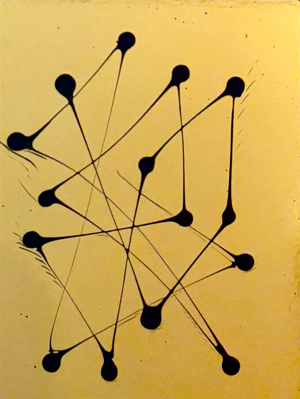 abstract minimal dots with lines connecting in black paint on gold shiny smooth reflective surface by m clark