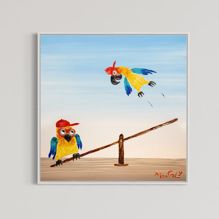 30” x 30” painting by French artist Moogly of two blue and yellow parrots with red baseball caps on a see-saw. One parrot is jumping on one end of the see-saw, making the other parrot fly up in the air. The parrots are made out of resin, giving them a textured and shiny finish. Their eyes are made out of washers that the artist has adhered to the canvas.