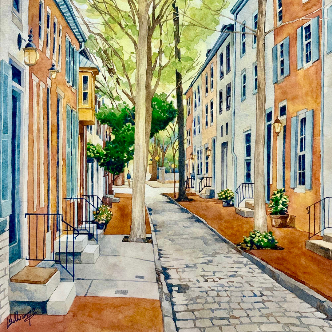 Watercolor painting of a residential street with a cobbled road and classic row homes